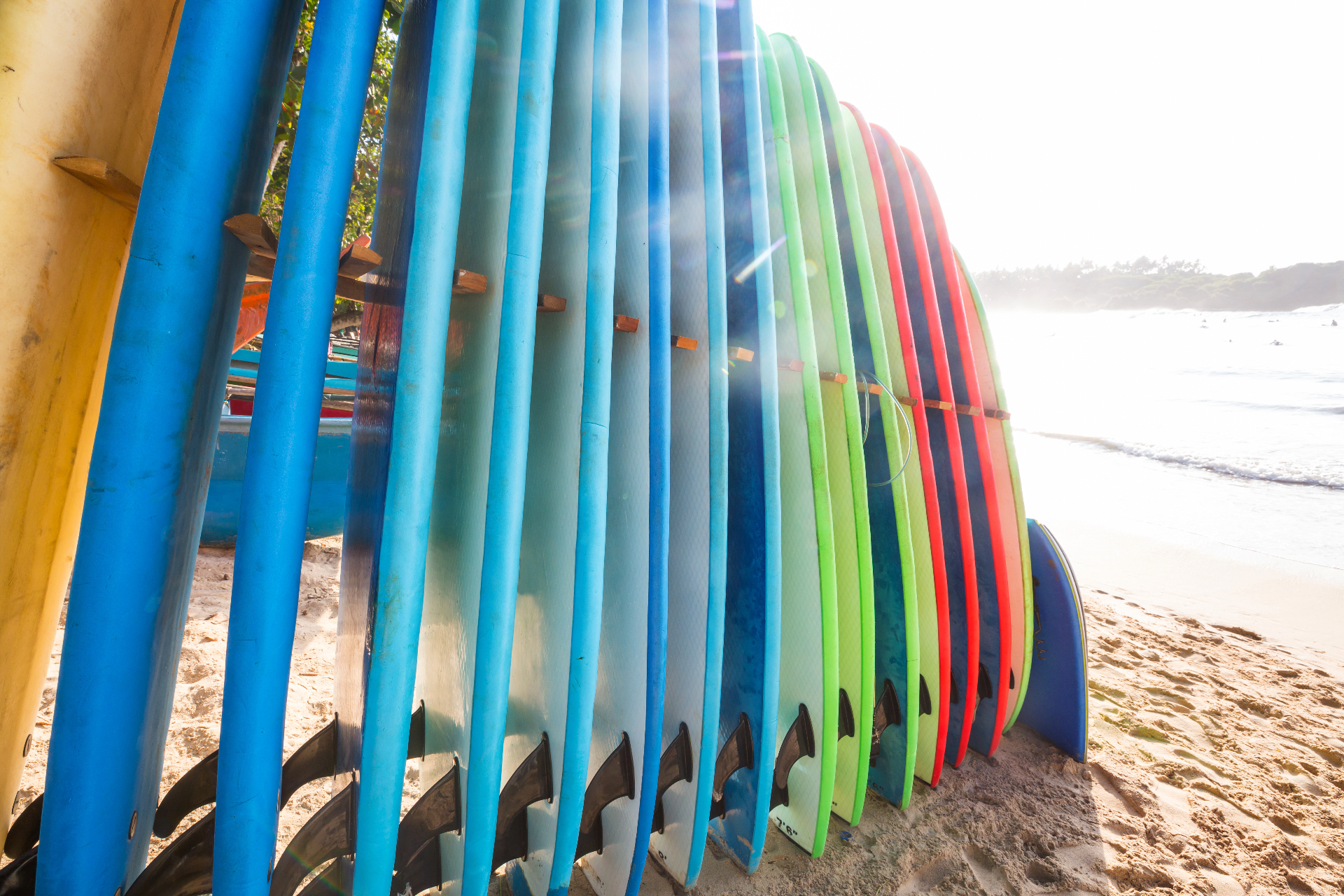 Colorful surfboards lined up on the beach at sunset in Manuel Antonio, Costa Rica